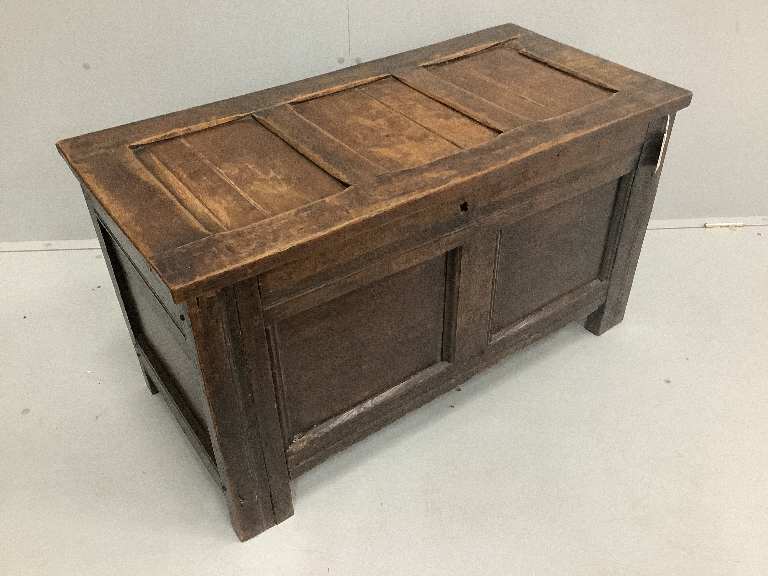 A small 17th century and later panelled oak coffer, width 99cm, depth 48cm, height 54cm